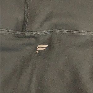 Dark green athletic leggings.